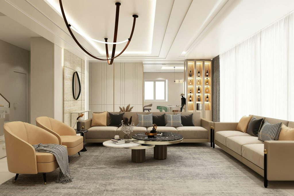 Stylish sitting area featuring beige sofas, elegant lighting, and chic decor.